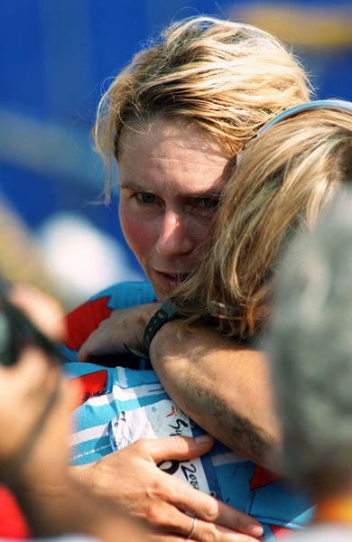Canada's Chrissy Redden receives a hug during a cross country cycling event at the 2000 Sydney Olympic Games. (CP PHOTO/ COA)