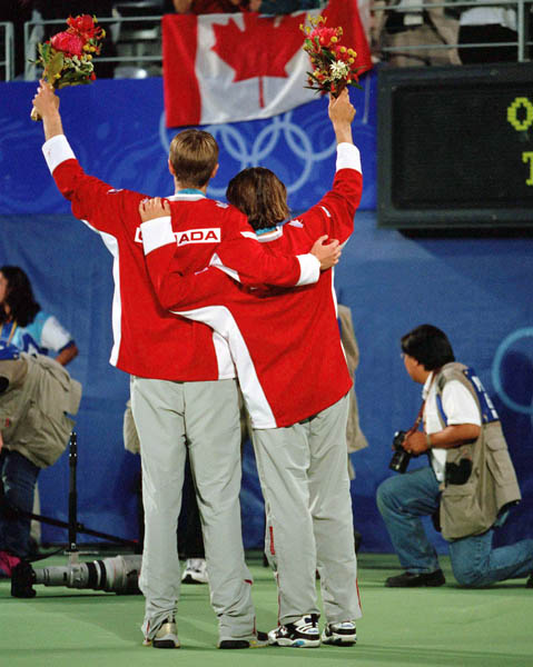 Canada's Daniel Nestor (left) and Sebastien Lareau celebrate after winning gold in men's doubles tennis action at the 2000 Sydney Olympic Games. (Mike Ridewood/CP Photo/ COA)
