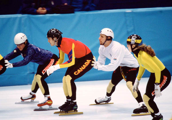 Canada's Derrick Campbell (red) and Marc Gagnon (white) compete in a short track relay speed skating event at the 1998 Nagano Winter Olympic Games. (CP Photo/ COA/ Scott Grant)