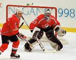 Canada's Allan MacInnis (2) and Patrick Roy (goalie) compete in hockey action against the United States at the 1998 Winter Olympics in Nagano. (CP Photo/COA/ F. Scott Grant )