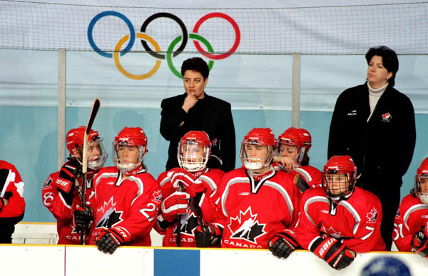Canada's women hockey coaches Shannon Miller (left) and Daniele Sauvageau look over their team at the 1998 Nagano Winter Olympics. (CP PHOTO/COA/Mike Ridewood)