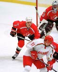 Canada's Chris Pronger (left) Joe Nieuwendyk (25) and Rob Zamuner (7) compete in hockey action at the 1998 Winter Olympics in Nagano. (CP Photo/COA/ F. Scott Grant )