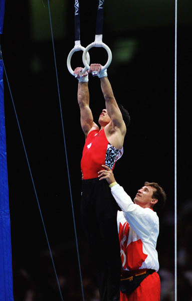 Canada's Alan Nolet and coach Dave Arnold compete in the gymnastics event at the 1996 Atlanta Summer Olympic Games. (CP Photo/COA/Claus Andersen)