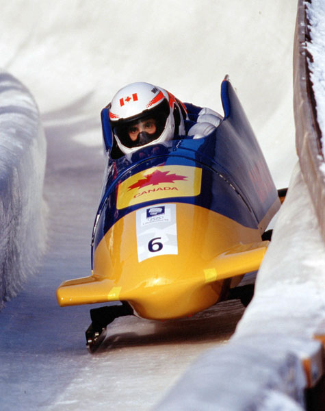 Canada's Chris Lori, Glenroy Gilbert, Sheridon Baptiste and Chris Farstad compete in the four-man bobsleigh event at the 1994 Lillehammer Winter Olympics. (CP Photo/ COA/F. Scott Grant)