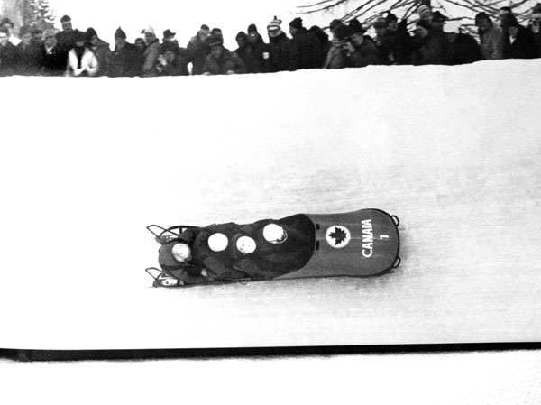 Canada's bobsleigh team, composed of Doug Anakin, Vic Emery, John Emery and Peter Kirby, compete in a gold medal performance at the 1964 Innsbruck winter Olympics. (CP Photo/COA)