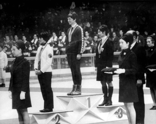 Canada's Nancy Greene (centre) celebrates her gold medal win in the giant slalom alpine ski event at the 1968 Grenoble winter Olympics. (CP Photo/COA)