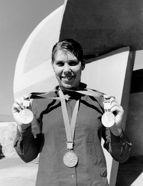 Canada's swimmer Elaine Tanner celebrates her silver medals in the 100m and 200m backstroke, and her bronze medal in the 4x100 freestyle race at the 1968 Mexico City Olympics. (CP Photo/COA)