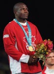 Canada's Daniel Igali stands on the podium after winning the gold medal for wrestling at the 2000 Sydney Olympic Games. (CP Photo/ COA)