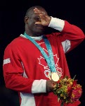 Canada's Daniel Igali stands on the podium after winning the gold medal for wrestling at the 2000 Sydney Olympic Games. (CP Photo/ COA)