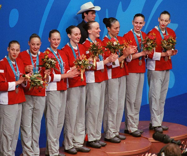 Canada's synchronized swimming team stands on the winners podium after having won the bronze medal at the 2000 Sydney Olympic Games. (CP Photo/ COA)
