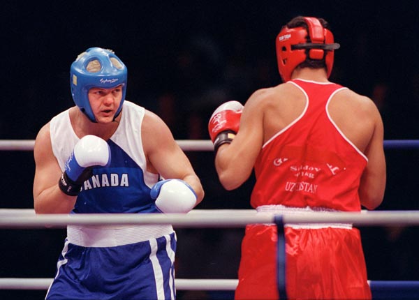 Canada's Artur Binkowski spars with his opponent in the ring at the 2000 Sydney Olympic Games. (CP Photo/ COA)