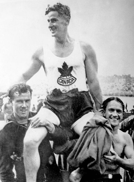 Canada's Francis Amyot celebrates a gold medal win in the 1,000m canoeing event at the 1936 Berlin Olympics. (CP Photo/COA)