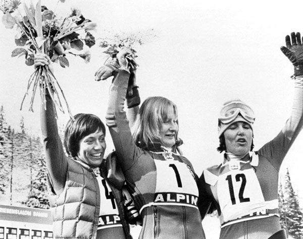 Canada's Kathy Kreiner (centre) celebrates her gold medal win the the giant slalom at the 1976 Winter Olympics in Innsbruck. (CP Photo/ COA)