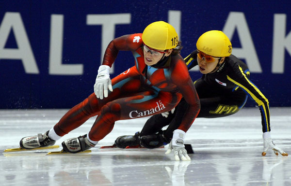 Canadian short track speed skater Isabelle Charest is followed closely by Japan's Chikage Tanaka during the Womens 500 metre in Salt Lake City, Utah Saturday Feb. 16, at the 2002 Winter Olympic Games.   (CP Photo/COA/Andre Forget)