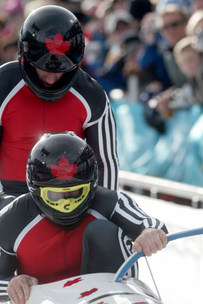 Canada's Pierre Leuders (front) and Giulio Zardo jump in the sled during the third run of two man bobsled at Utah Olympic Park during the Winter Olympics, Sun., Feb. 17, 2002, 2002.  (CP PHOTO/COA/Mike Ridewood)
