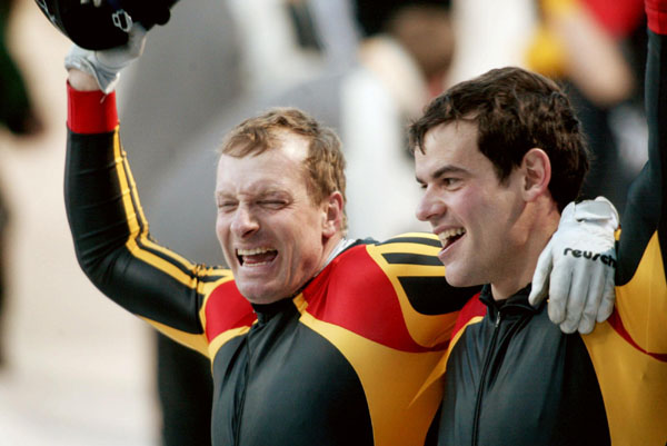 Christoph Langen (left) and Markus Zimmermann of Germany celebrate their gold medal run of two man bobsleigh at Utah Olympic Park during the Winter Olympics, Sun., Feb. 17, 2002, 2002.  (CP PHOTO/COA/Mike Ridewood)