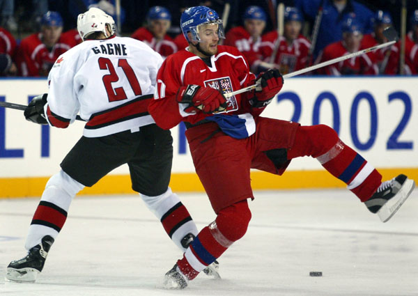 Team Canada Simon Gagne hauls down Czech Petr Sykora  during the first period of the Final Round of game 26 Monday Feb. 18, at the 2002 Winter Olympic Games in Salt Lake City. The final score was 3-3. (CP Photo/COA/Andre Forget)
