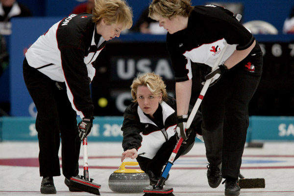 Canadian skip Kelley Law throws skip rock as sweepers Diane Nelson (right) and Georgina Wheatcroft get into position during Canada's bronze medal win over the United States 9 - 5 at Ogden , Utah during the Winter Olympics, Thursday, Feb. 21, 2002  (CP PHO