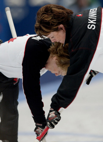 Canada's Diane Nelson (left) and Julie Skinner work hard sweeping a rock during Canada's bronze medal win in women's curling, beating the U.S.A. 9 - 5 at Ogden , Utah during the Winter Olympics, Thursday, Feb. 21, 2002  (CP PHOTO/COA/Mike Ridewood)