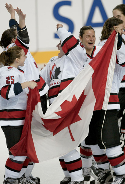 Members of Canada's women's hockey team including Dana Antal (25) celebrate Canada's gold medal game win 3 - 2  over the United States in Salt Lake City , Utah during the Winter Olympics, Thursday, Feb. 21, 2002  (CP PHOTO/COA/Mike Ridewood)