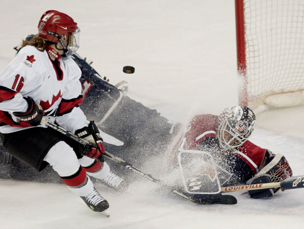 Canada's Jayna Hefford scores the team's third goal over United States goaltender Sara Decosta in the second period of a 3 - 2 Canada win for the gold medal  over the United States in Salt Lake City , Utah during the Winter Olympics, Thursday, Feb. 21, 20