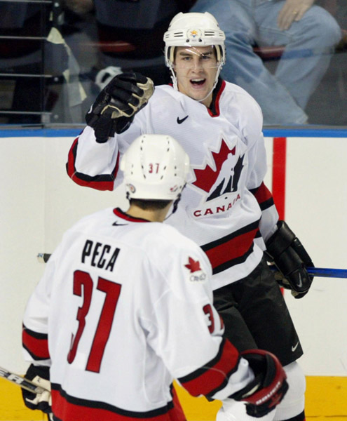 Eric Gagne of Team Canada celebrates with team mate Mike Peca after scoring the fifth goal against Team Belarus goalie Sergei Shabanov during the third period of Olympic hockey action Friday Feb. 22, 2002 at the 2002 Winter Olympic Games in Salt Lake City