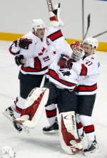 Joe Sakic (L-R)  of Team Canada is surrounded by teammates Steve Yzerman, Jarome Iginla and Scott Niedermayer after he scored goal five on Team USA goalie Mike Richter Sunday Feb. 24, 2002 at the 2002 Winter Olympic Games in Salt Lake City. Team Canada wo