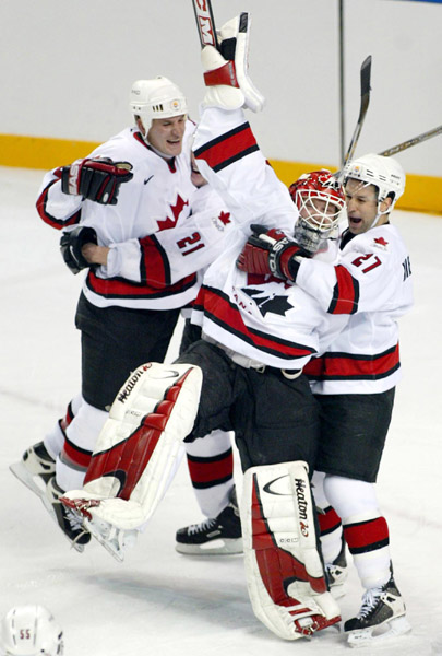 Team Canada goalie Martin Brodeur celebrates with teammates (left to right) Adam Foote, Simon Gagne and Scott Niedermayer as win the gold medal over Team USA Sunday Feb. 24, 2002 at the 2002 Winter Olympic Games in West Valley, Utah. Team Canada won 5-2 o