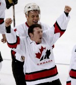 Joe Sakic of Team Canada is surrounded by teammates Steve Yzerman, Jarome Iginla and Scott Niedermayer after he scored goal five on Team USA goalie at the 2002 Olympic Winter Games in Salt Lake City. Team Canada won 5-2 over Team USA.  (CP Photo/COA/Andre Forget).