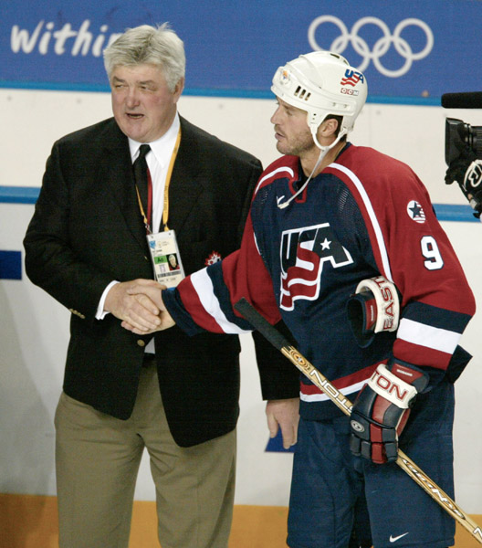 Canada's men's team coach Pat Quinn is congratualated by Mike Modano of the U.S.  after Canada defeated the U.S. 5 - 2 to take the gold medal at the Winter Olympics in West Valley City, Utah, Sun., Feb. 24, 2002 . (CP PHOTO/COA/Mike Ridewood)