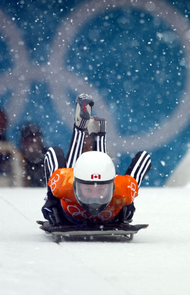 Canadian women's skeleton rider Lindsay Alcock of Calgary jumps onto her sled as she slides down the track at the 2002 Olympic Winter Games in Salt Lake City. (CP Photo/COA/Andre Forget).