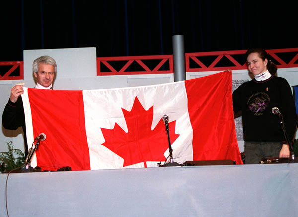 Canada's Sylvie Daigle and Walter Sieber hold up the Canadian flag at the 1992 Albertville Olympic winter Games. (CP PHOTO/COA/Ted Grant)