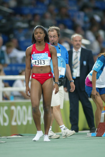 Canada's Perdita Fellicien of Pickering, Ont. leaves the track after crashing in the women's 100 metre hurdles final in track and field action at the Athens Olympics, Tuesday, August 24, 2004.(CP PHOTO)2004(COC-Mike Ridewood)