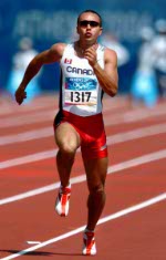 Canadian sprinter Nicolas Macrozonaris of Laval, Quebec, runs during the 100m heat during the Athens 2004 Summer Olympic Games Saturday, August 21, 2004. Macrozonaris crossed the line with a time of 10.40 to move on. (CP PHOTO/COC-Andre Forget)