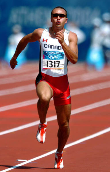 Canadian sprinter Nicolas Macrozonaris of Laval, Quebec, runs during the 100m heat during the Athens 2004 Summer Olympic Games Saturday, August 21, 2004. Macrozonaris crossed the line with a time of 10.40 to move on. (CP PHOTO/COCAndre Forget)