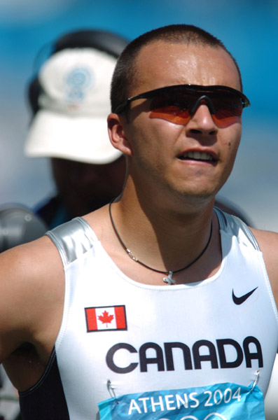 Canadian sprinter Nicolas Macrozonaris of Laval, Quebec, crossed the line with a time of 10.40 to move on during the 100m heat at the 2004 Summer Olympic Games in Athens on Saturday, August 21, 2004. (CP PHOTO/COC-Andre Forget)
