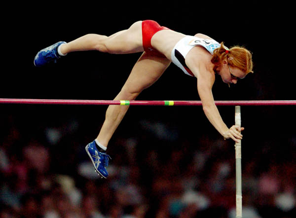 Stephanie McCann of North Vancouver, B.C., jumps over the bar during the pole vault qualification during the Athens 2004 Summer Olympic Games August 21, 2004.(CP PHOTO /COC-Andre Forget)