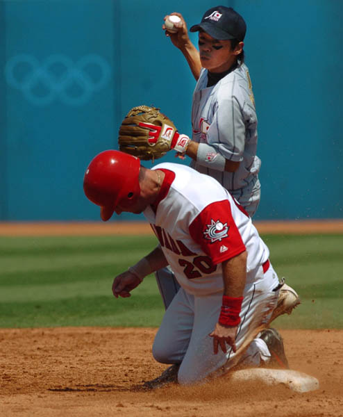 Canada's mens baseball team player Todd Betts is out at second base by Japan's Atsushi Fujimoto during forth inning bronze medal Olympic baseball action during the Athens 2004 Summer Olympic Games Wednesday August 25, 2004. Japan went on to win bronze. (CP PHOTO/COC-Andre Forget)