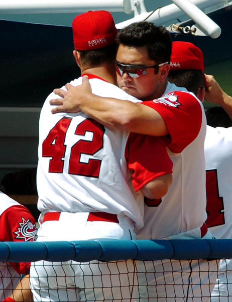 Canada's mens baseball team coach Denis Boucher (left) hugs Kevin Nicholson after losing bronze to Japan 11-2 during Olympic Baseball at the Athens 2004 Summer Olympic Games Wednesday August 25, 2004. Japan went on to win bronze. (CP PHOTO/COC-Andre Forget)