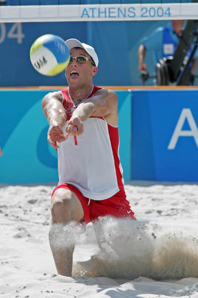 John Child of Scarborough, Ont. digs for the ball in Canada's loss to Switzerland in beach volleyball at the Athens Olympics, Saturday, August 14, 2004.  (CP PHOTO/COC-Mike Ridewood)