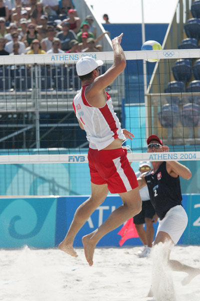 John Child of Scarborough, Ont. hits the ball in Canada's loss to Switzerland in beach volleyball at the Athens Olympics, Saturday, August 14, 2004. (CP PHOTO/COC-Mike Ridewood)