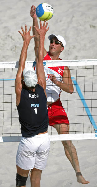 John Child of Scarborough, Ont. goes for the ball against Stefan Kobel of Switzerland in Canada's loss at beach volleyball at the Athens Olympics, Saturday, August 14, 2004.  (CP PHOTO/COC-Mike Ridewood)