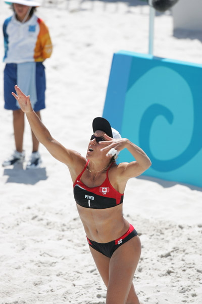 Guylaine Dumont of St-Antoine-de-Tilly, Que., gets ready to hit the ball against Switzerland in Canada's victory at beach volleyball at the Olympic Games in Athens, Saturday, August 14, 2004. (CP PHOTO/COC-Mike Ridewood)