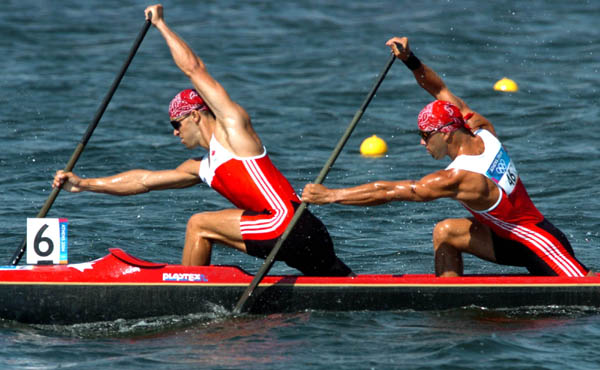 Canada's Attila Buday (front) and Tamas Jr. Buday race in boat 6 during the C2 500m heat during the Athens 2004 Summer Olympic Games Tuesday August 24, 2004. The pair placed second in the heat. (CP PHOTO/COC-Andre Forget)