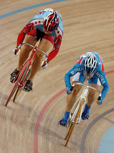 Canada's Lori-Ann Muenzer of Edmonton (left) races against Russian Tamilla Abassova during the  gold medal race in the women's sprint cycling event at the 2004 Summer Olympic Games in Athens, Greece, Tuesday, August 24, 2004.(CP PHOTO/COC/Andre Forget)