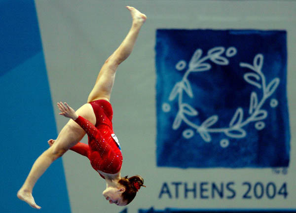 Melanie Banville of Canada flies over the Beam during women's gymnastics qualifications at the 2004 Olympic Games in Athens, Sunday, Aug. 15, 2004. (CP PHOTO/COC-Andre Forget)