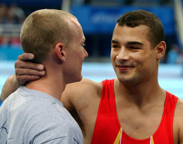Kyle Shewfelt (left) of Calgary congratulates gold medal winner Gervasio Deferr of Spain after the men's vault final at the 2004 Summer Olympic Games in Athens, Greece, Monday, August 23, 2004. Shewfelt came in fourth. (CP PHOTO/COC/Andre Forget)