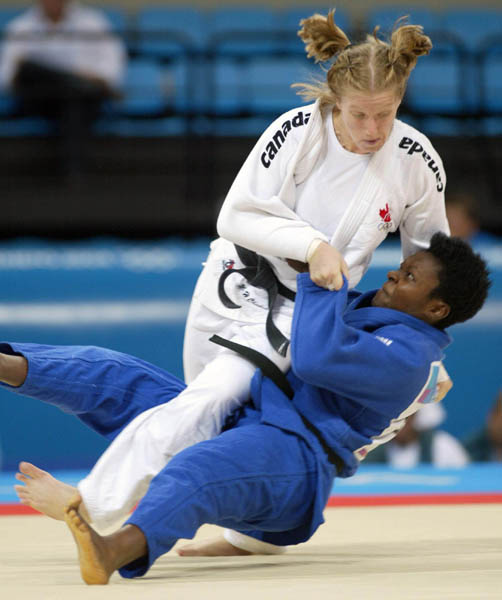 Canada's Amy Cotton, top, from Varennes, Que., battles Italy's Lucia Morico during their second round  -78kg judo competition at the Summer Olympics in Athens Thursday, August 19, 2004. Lucia won the match.  (CP PHOTO/COC-Mike Ridewood)