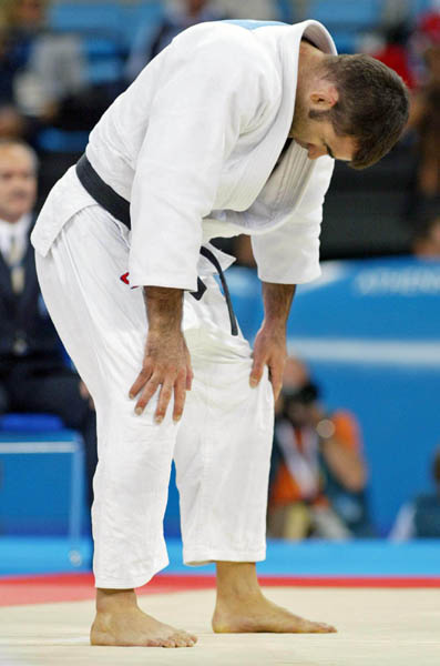 Canada's Nicolas Gill, from Montreal, reacts after his match against Italy's Michele Monti in the -100kg judo competition at the Summer Olympics in Athens Thursday, August 19, 2004. Gill, Canada's flag bearer and medal hopefull, lost the first round match. (CP PHOTO/COC-Mike Ridewood)