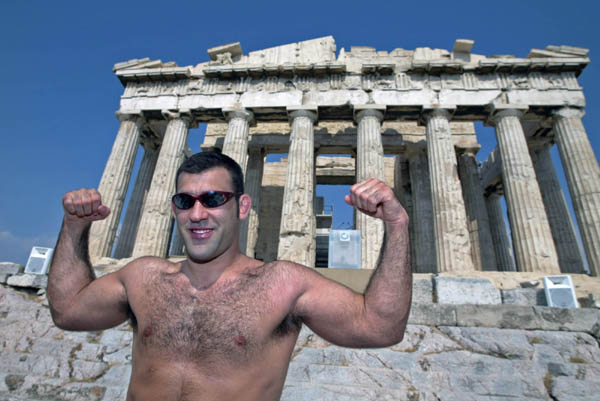 Judo athlete Nicolas Gill of Montreal does a muscle pose in front of the Parthenon in Athens, Thursday, August 10, 2004. Gill will carry the flag to lead the Canadian team at the opening ceremonies of the Olympics on Friday. (CP PHOTO/COC-Mike Ridewood)
